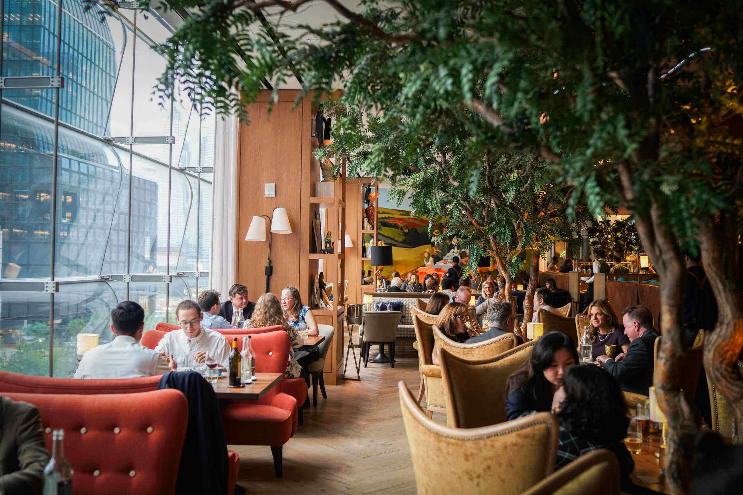 Artificial indoor Acacia trees with diners in Queensyard Restaurant