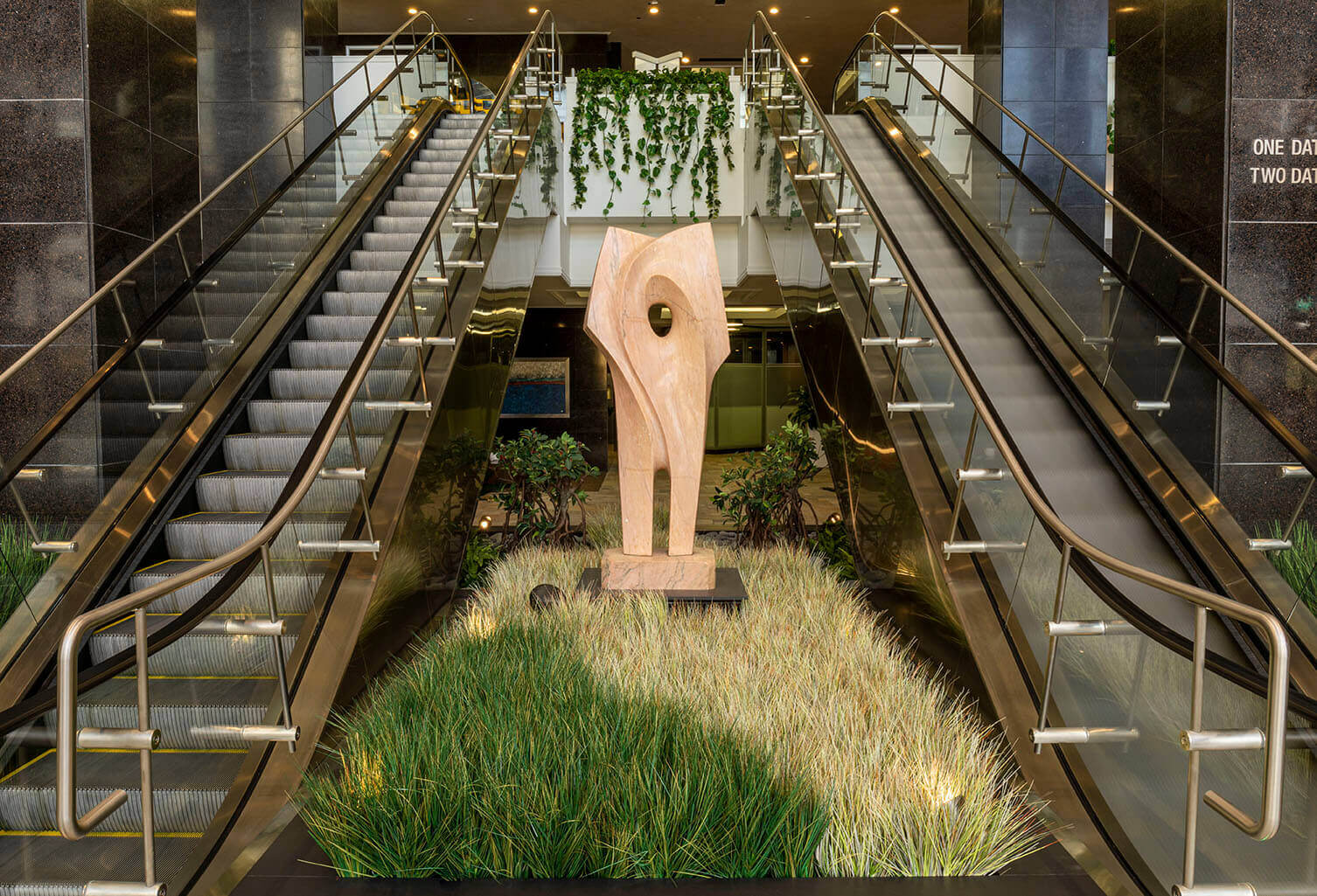 Artificial Onion Grass at the base of sculpture between escalators at Datran Business Center