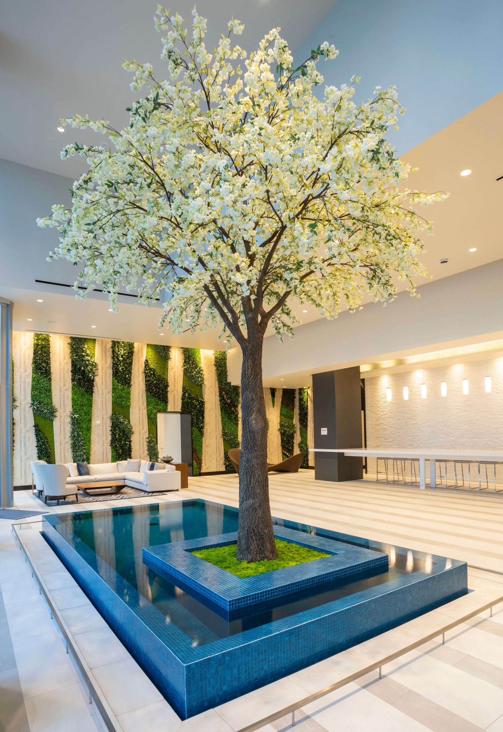 Fabricated Cherry Blossom Tree in infinity edge reflecting pool with Vertical Garden in background 1