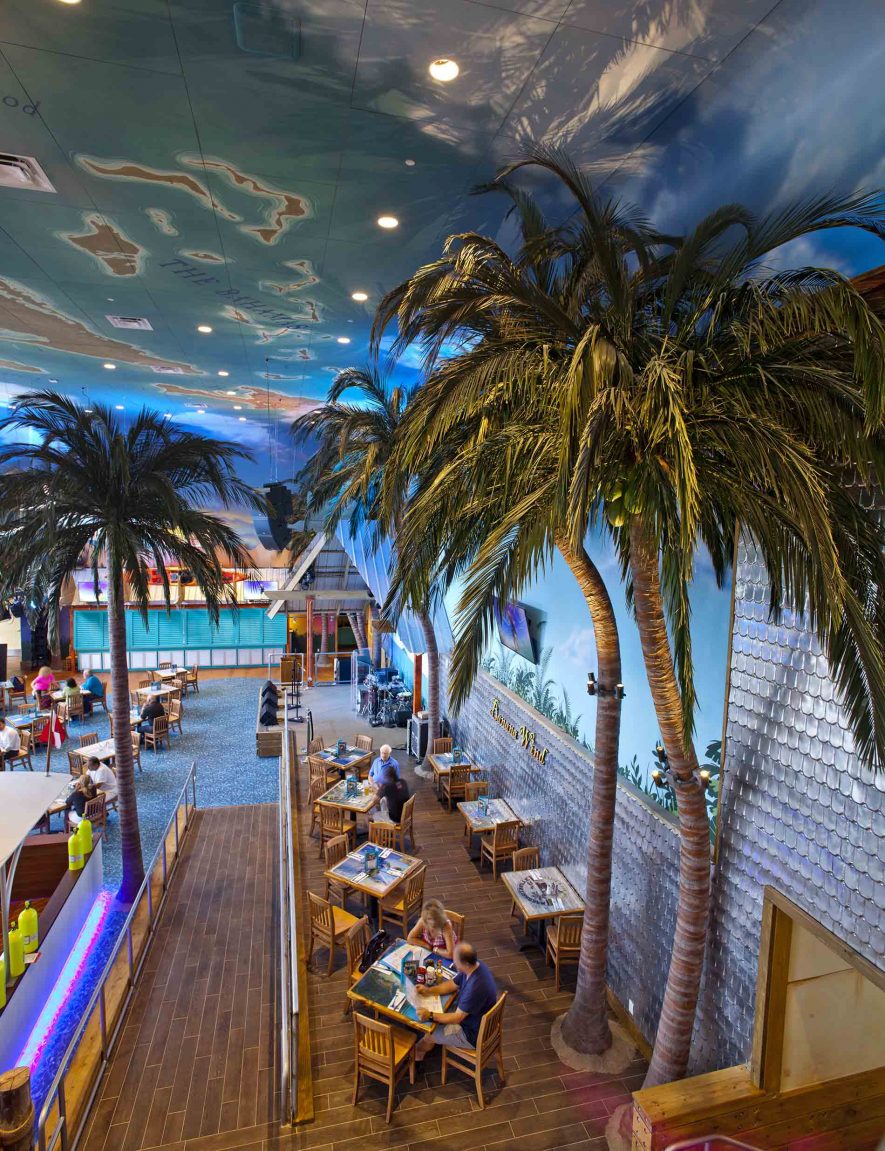 High angle floor to ceiling view showing dining area & Fabricated Coconut Palm Trees at Margaritaville Restaurant, Las Vegas
