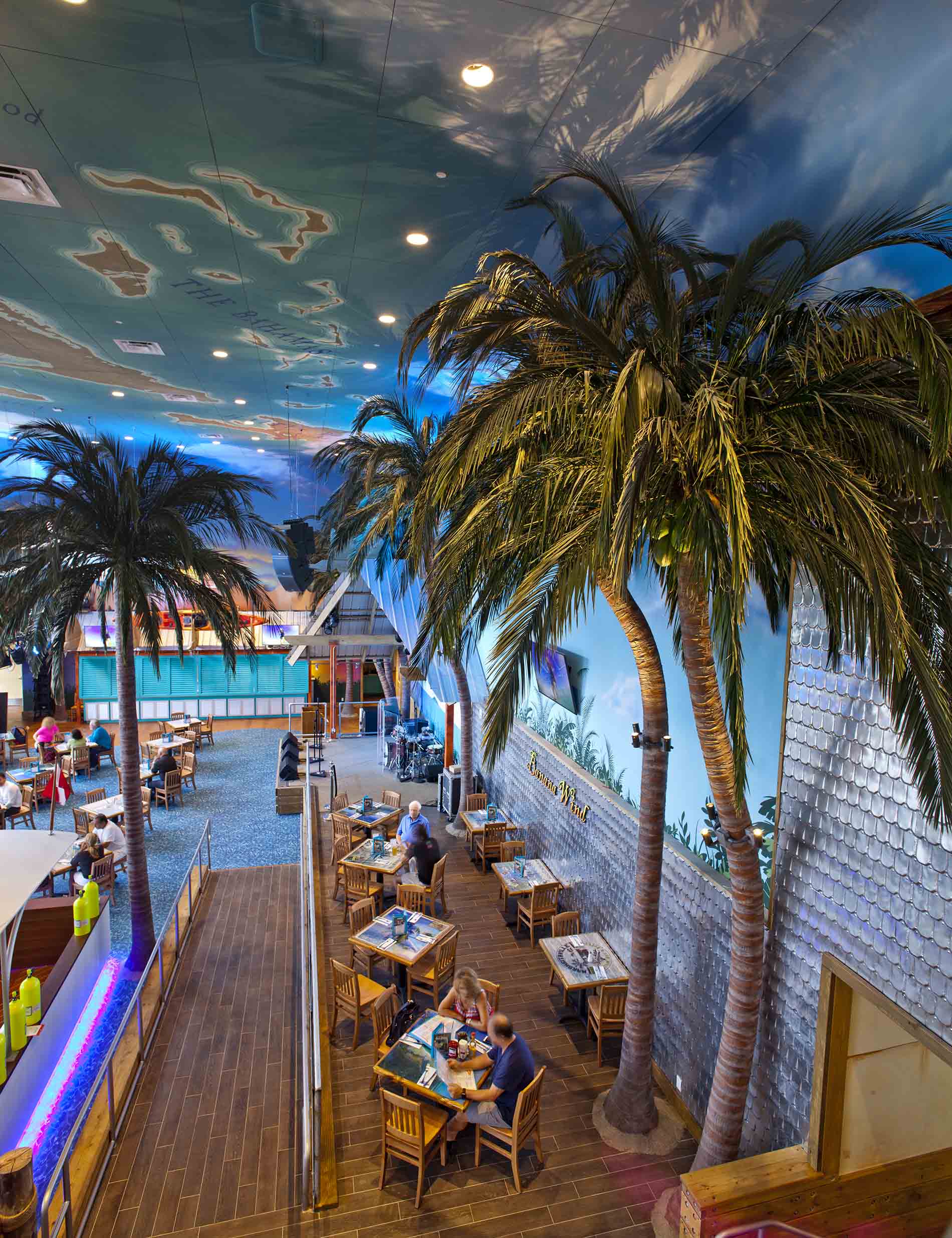 High angle floor to ceiling view showing dining area & Fabricated Coconut Palm Trees at Margaritaville Restaurant, Las Vegas
